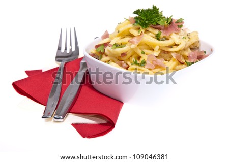 Cheese Spaetzle with cutlery isolated on white background