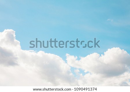 Bright blue sky with white fluffy clouds below the background. Nature cloudscape background in Sunny summer day, texture for Design. Beautiful Web banner or Wallpaper With Copy Space for website