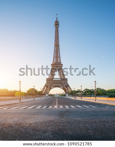 small paris street with view on the famous paris eiffel tower on a sunny day with some sunshine Royalty-Free Stock Photo #1090521785