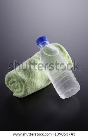 Bottled Water and a Towel on the gray background