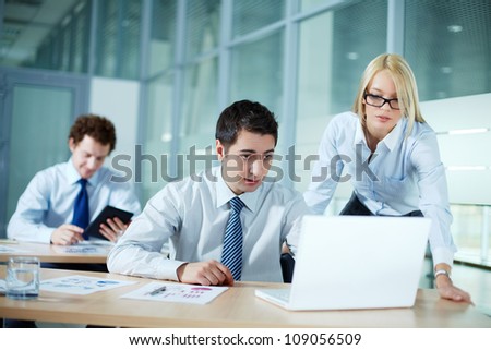 Portrait of business colleagues working with laptop
