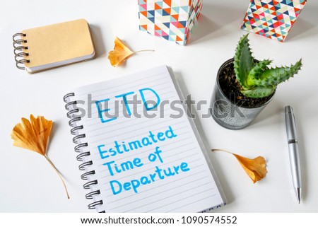 ETD Estimated Time Of Departure written in notebook on white table