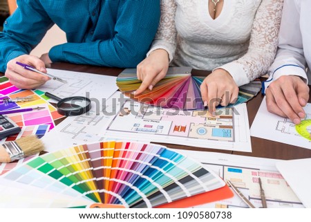 Teamwork of designers choosing colors for rooms in house
