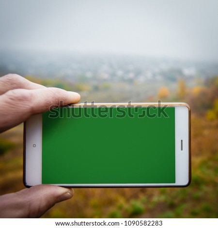 Photographing autumn nature, green chroma key on screen