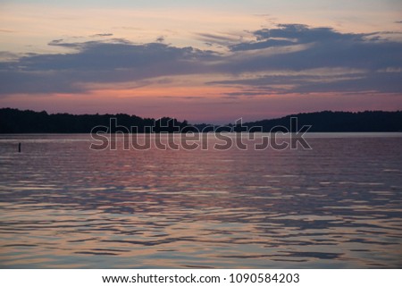 Calm and peace on the lake.  Natural and colorful sunset 