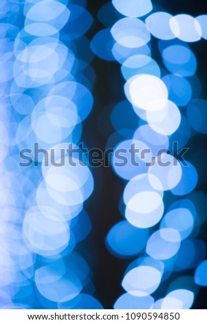 Glow of blue lights blurry against a dark background