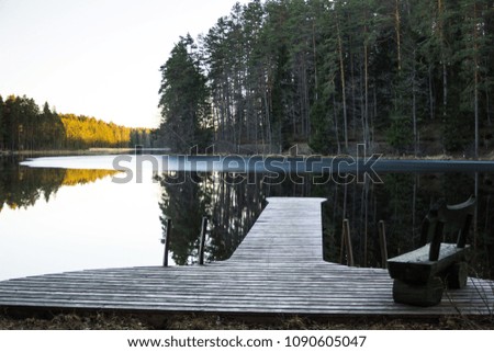 Early Spring Evening with the Footbridge on the Side of the Lake, with the Forest in the Background