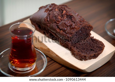 Home made delicious cocoa cake over wooden plate and Turkish tea