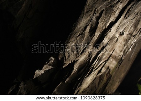 Rock formations under controlled lighting in a cave