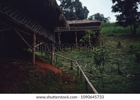 The traditional hill tribe house build from wood stilts and feature thatch roofs at Chiang Mai northern of Thailand.