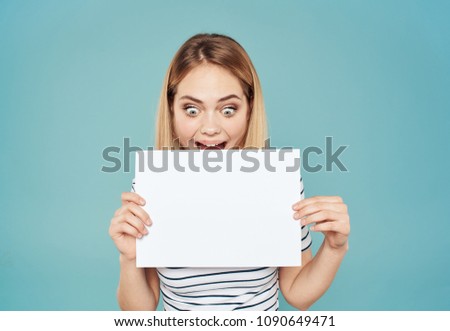 happy blonde looking at a sheet of paper                        
