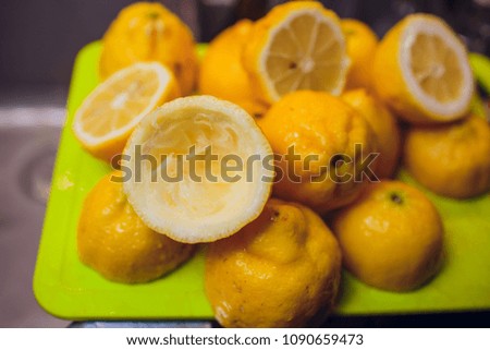 close-up picture of bartender's hands cutting raw, ripe and fresh green lime Exotic fruity beverage preparation composition.