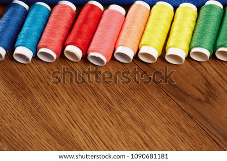 DIY concept. Sewing supplies: sewing thread, scissors, a spool of thread, pieces of cloth, needles,centimeter