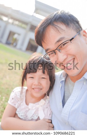 cute girl with father selfie in the park