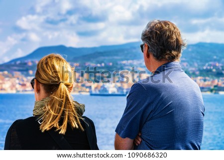 Couple looking at the Mediterranean Sea and landscape in Reggio Calabria, Italy