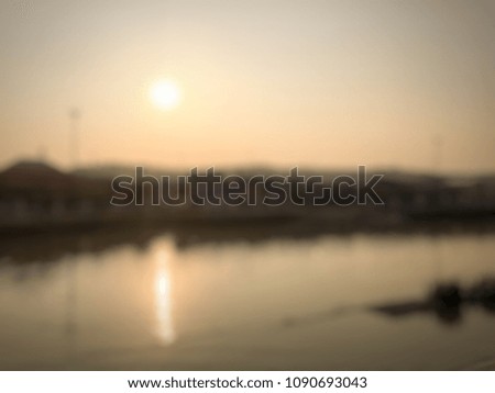 Blurred background of sunset shadow silhouetted orange sky on the river