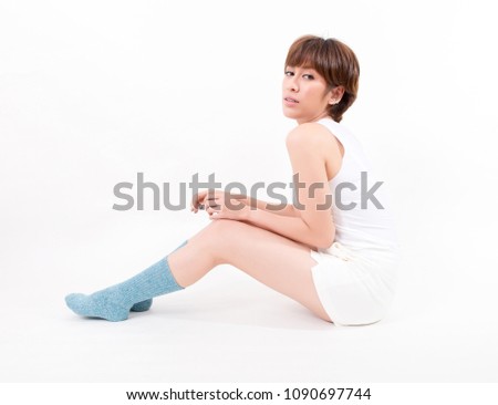 Blue cotton socks on beautiful woman's feet. Isolated on white background. Studio lighting. Concept for healthy and medical