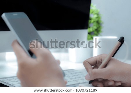 Close-up of Business female working with laptop, coffee, clock, smart phone, and notebook on office.