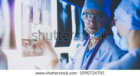 Two female women medical doctors looking at x-rays in a hospital. Royalty-Free Stock Photo #1090724705