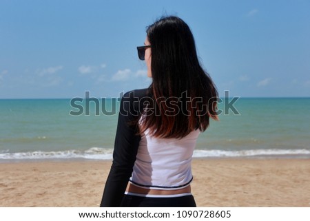 Portrait of beautiful woman on the beach vacation getaway travel holiday destination. In hand holding diving equipment at the summer waterfront. Happy Holidays concept.
