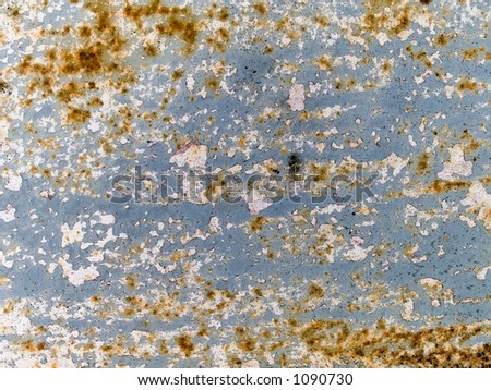 Stock macro photo of the texture of rusty metal under peeling paint.  Userful for layer masks and abstract backgrounds.