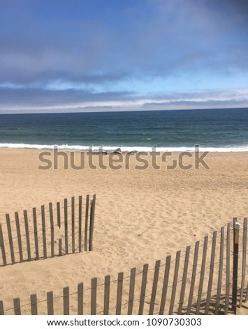 Salisbury, Massachusetts, May 10, 2018, Boardwalk to sandy beach with waves breaking on shore