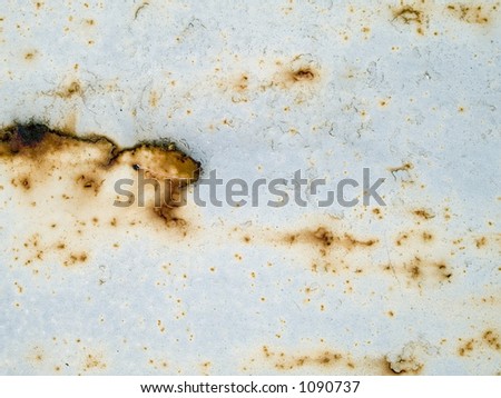 Stock macro photo of the texture of rusty metal under peeling paint.  Userful for layer masks and abstract backgrounds.