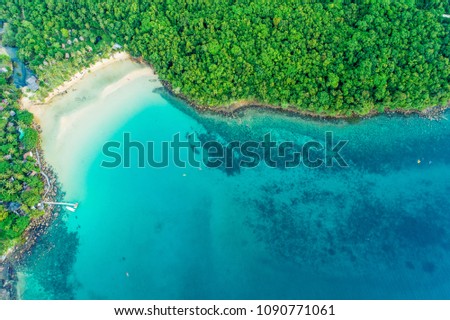Exotic idyllic sea island with green tree forest aerial view