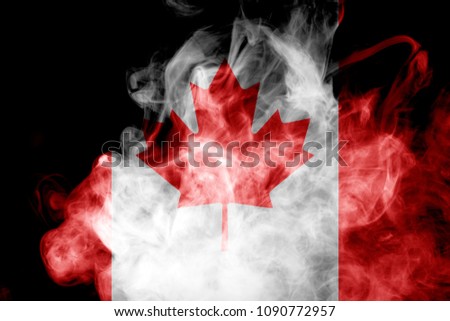 National flag of Canada from thick colored smoke on a black isolated background