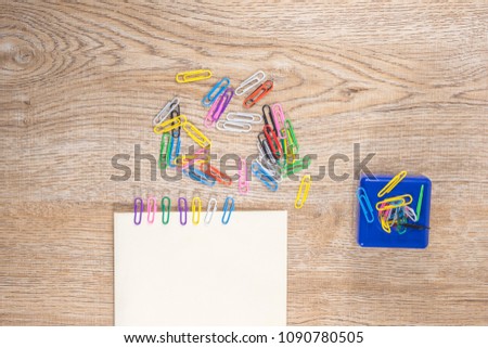 Magnetic box  for put paper clips and Paper Clips colorful on wooden floor