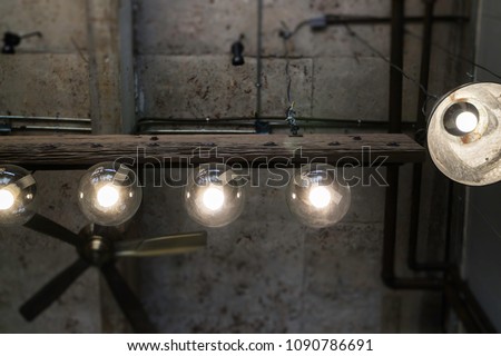 Light bulbs hanging from ceiling, stock photo
