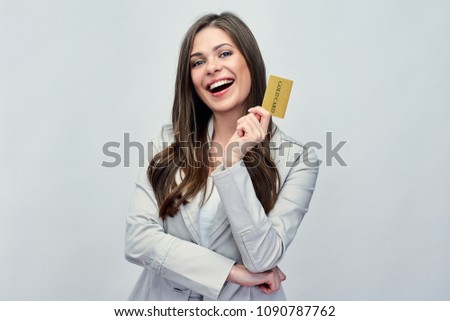 Smiling business woman holding gold credit card. Businesswoman in business suit isolated studio portrait.