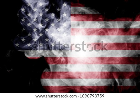 National flag of USA from thick colored smoke on a black isolated background