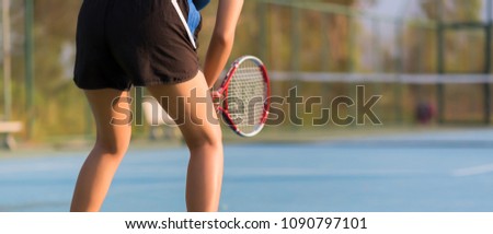 Woman playing tennis and waiting for the service. banner panoramic crop for copy space.