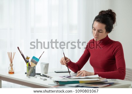 the girl draws on canvas. artist's workplace