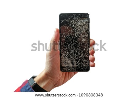 Hands holding broken mobile smartphone with broken screen isolated on white background. Cracked glass on a black telephone in the form of a web.