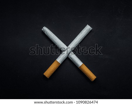 World No Tobacco Day, Broken cigarette isolated on black background. No smoking concept.