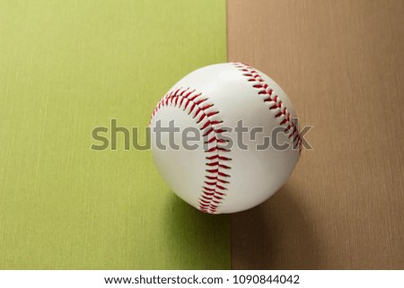 Rigid baseball ball and green and brown background
