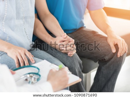 Patient couple having doctor or psychologist consulting on marriage counseling, family medical healthcare therapy, IVF insemination fertility treatment for infertility or psychotherapy session concept Royalty-Free Stock Photo #1090871690