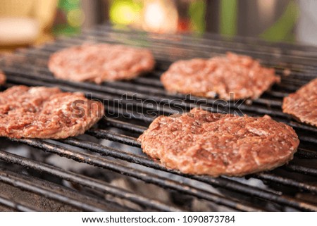 Roast on a grill cutlets for burgers on coals