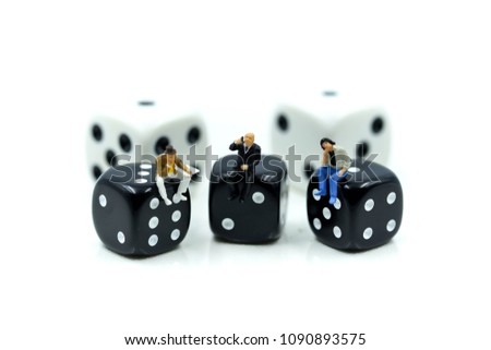 Miniature people : businessman sitting with dices,relax Business Concept.