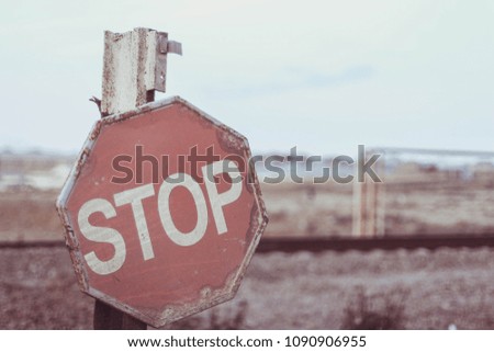 The old stop road sign at the railroads
