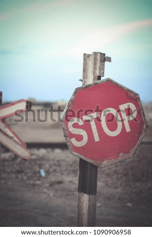 The old stop road sign at the railroads