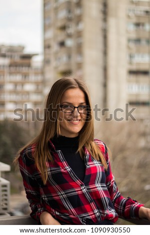 Girl with a glasses posing and smiling