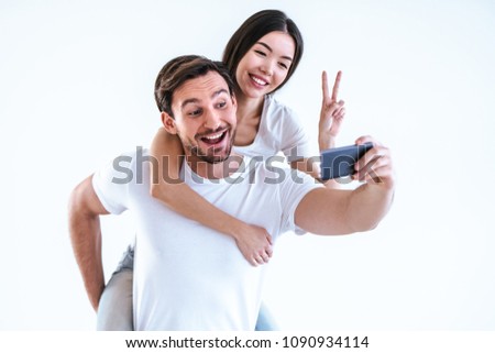 The happy couple making a selfie on a white background