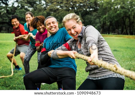 Team competing in tug of war Royalty-Free Stock Photo #1090948673