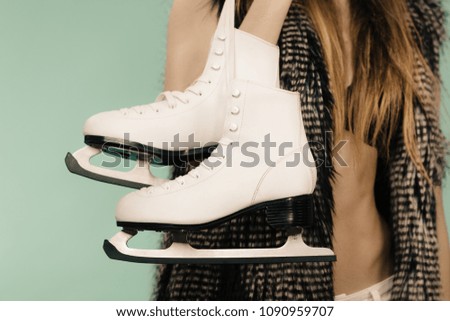 Winter, sport, people concept. Lady with ice skates close up