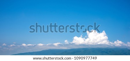 image of blue sky and mountain in background.