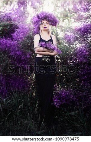 a girl in lilac blossoms