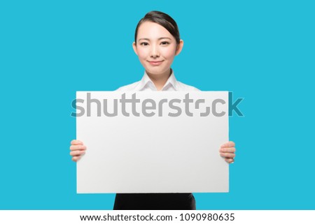 Young businesswoman holding a sign board.